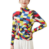 Colorful geometric-patterned sweater worn by a person on a white background