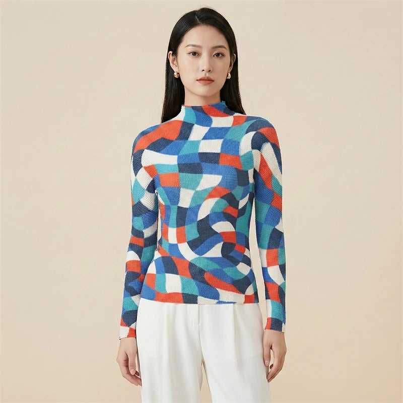 Woman wearing a colorful geometric-patterned sweater against a beige background