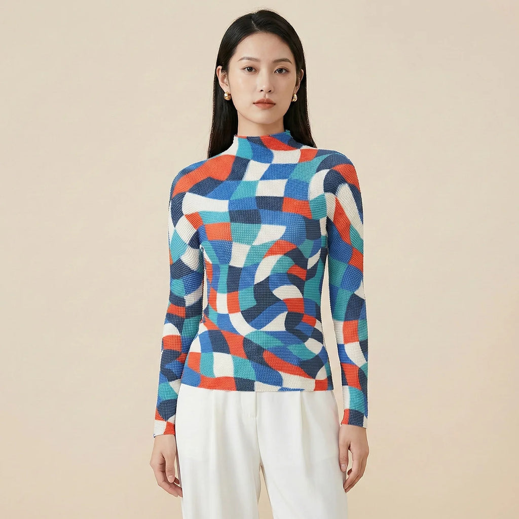 Woman wearing a colorful geometric-patterned sweater against a beige background