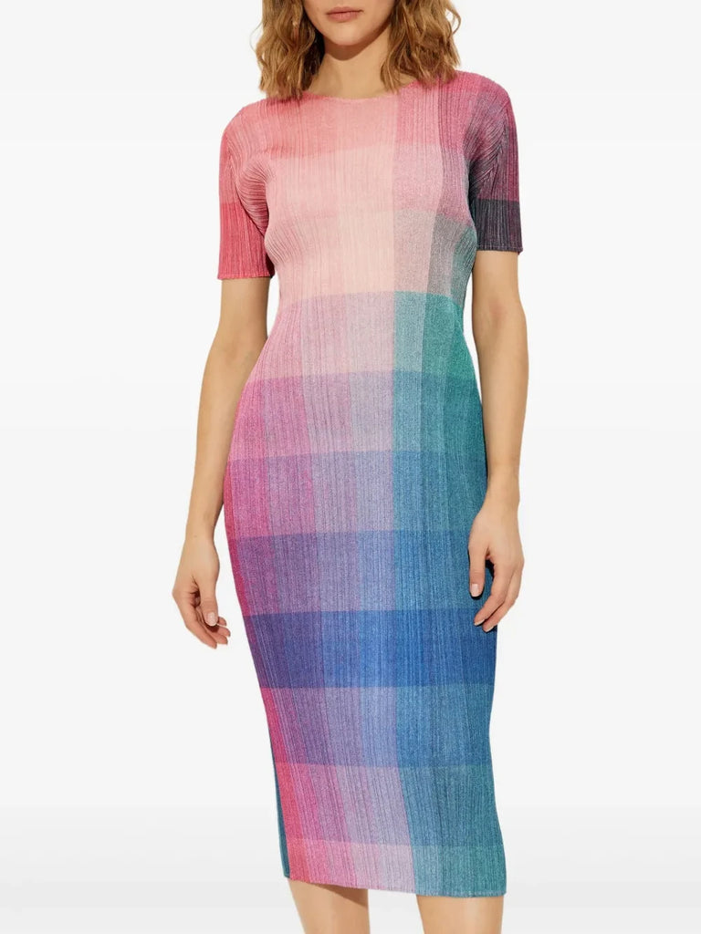Woman wearing a colorful checkered dress on a white background