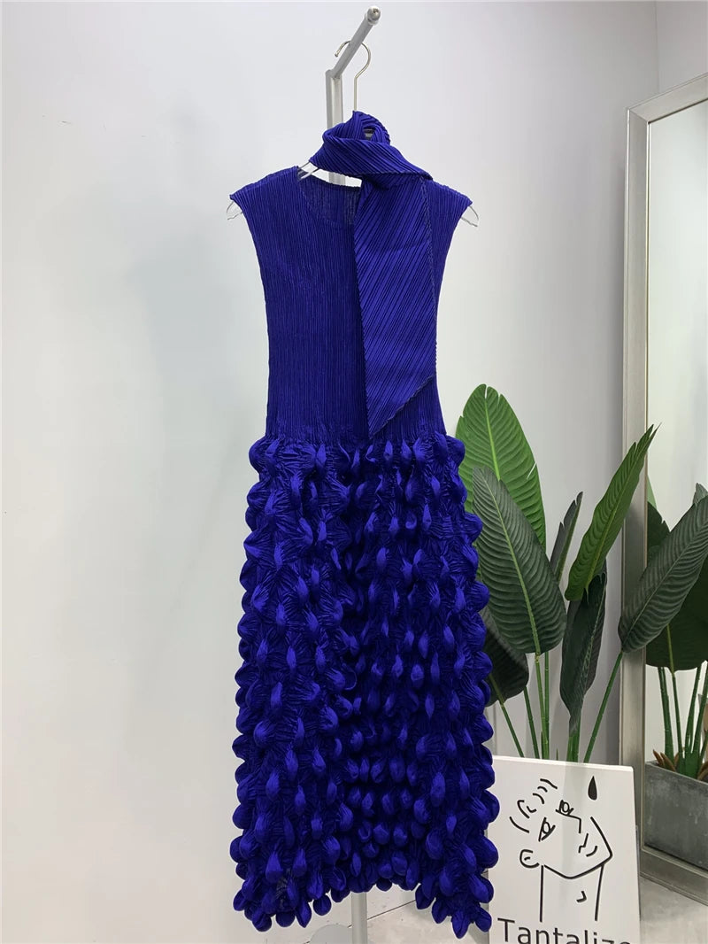 Blue dress with floral details on a hanger against a light background