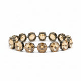 Gold bracelet with large crystals on a blurred background