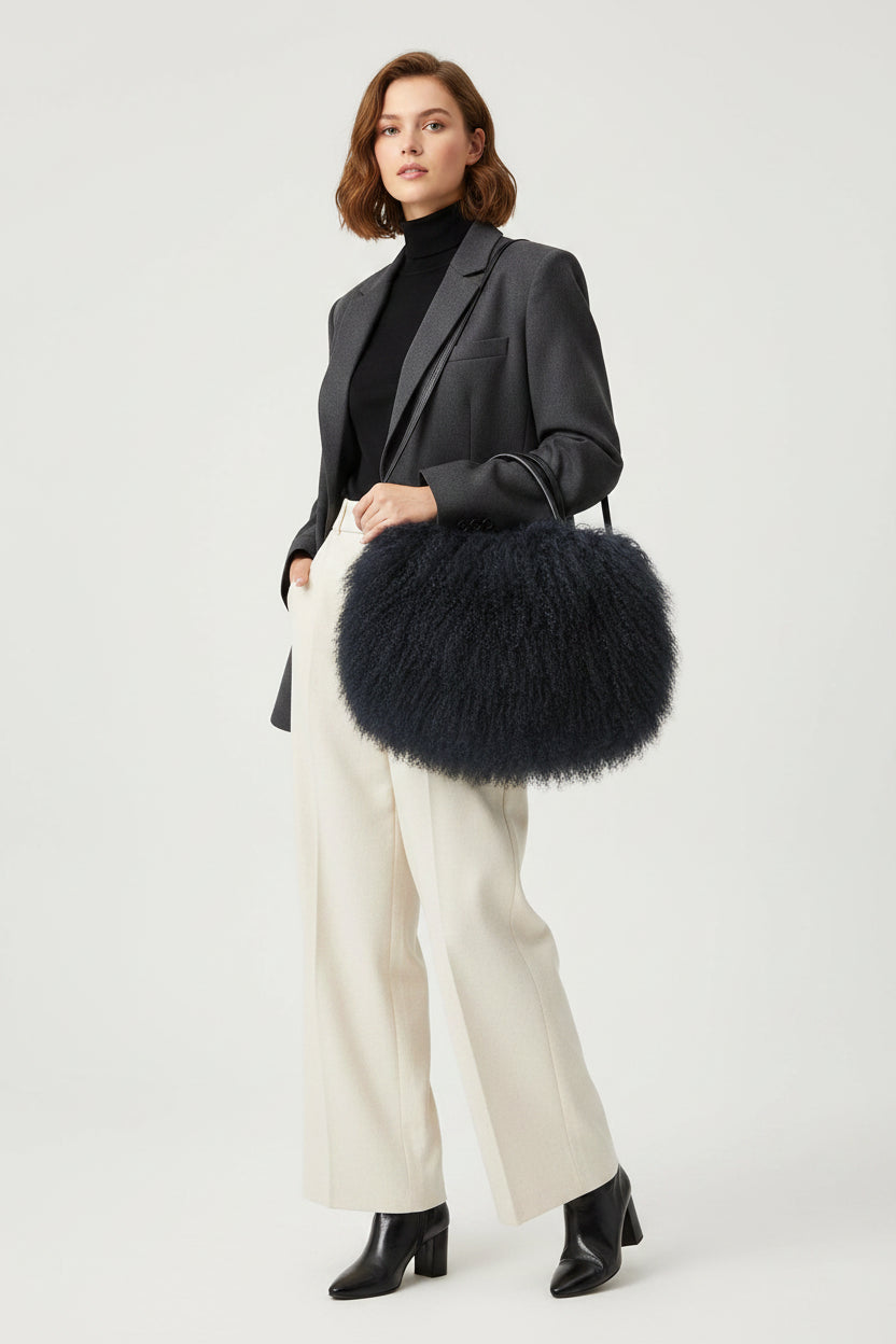 Black fluffy handbag on a white background