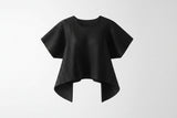 Black pleated top on a white background with a lamp and wooden cabinet.