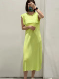 Person wearing a bright yellow dress against a plain background