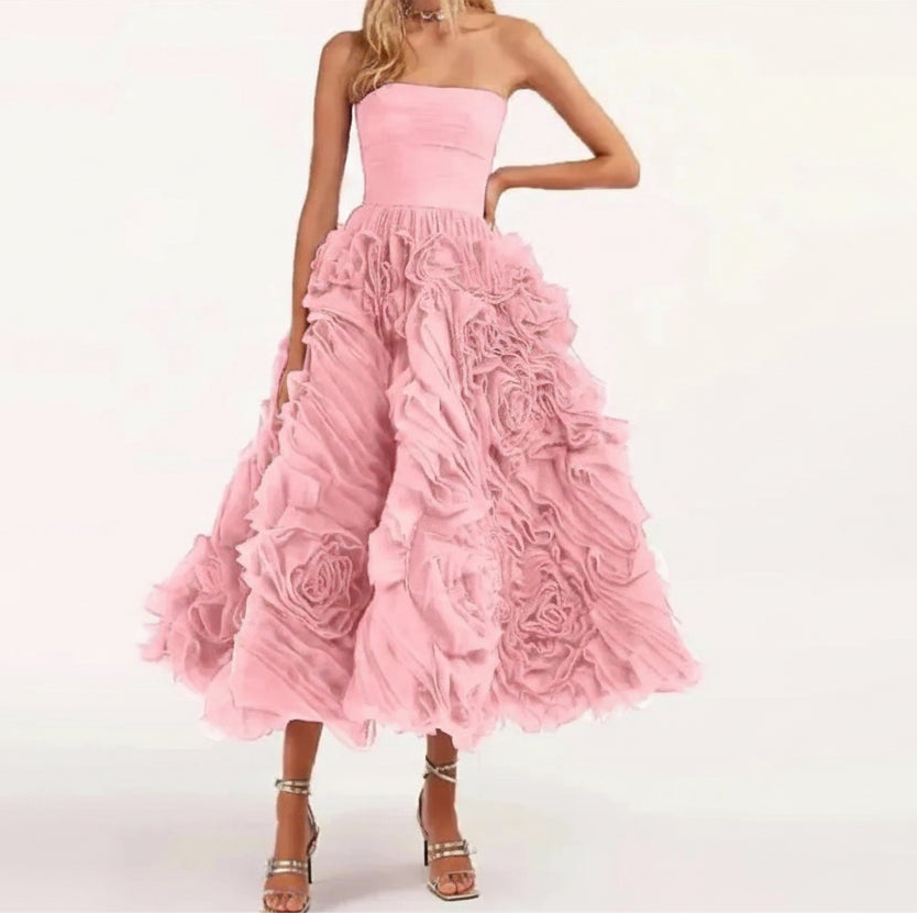 Pink strapless dress with floral details on a white background