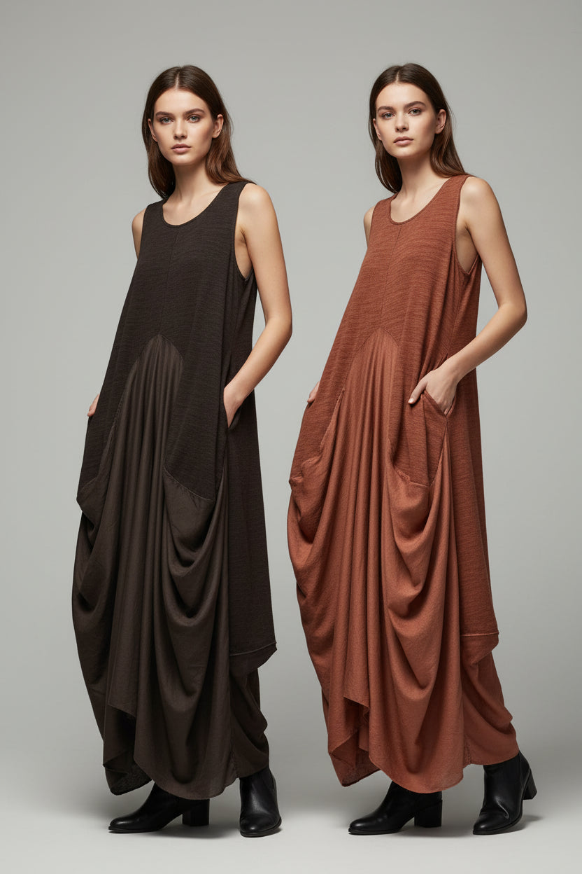 Two dresses, one brown and one rust-colored, hanging on a rack against a gray wall.