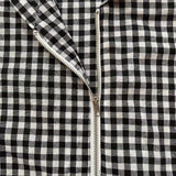 Close-up of a black and white checkered fabric with a zipper.