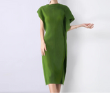 Green dress worn by a model on a white background