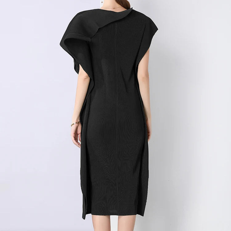 Woman wearing a black dress with a plain white background