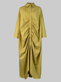 Yellow dress with ruched design on a gray background
