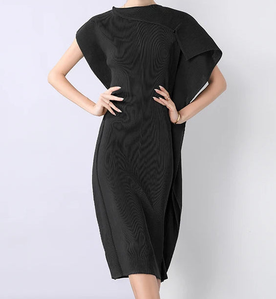 Woman wearing a black dress against a white background