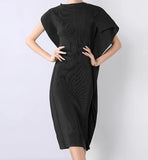 Woman wearing a black dress against a white background