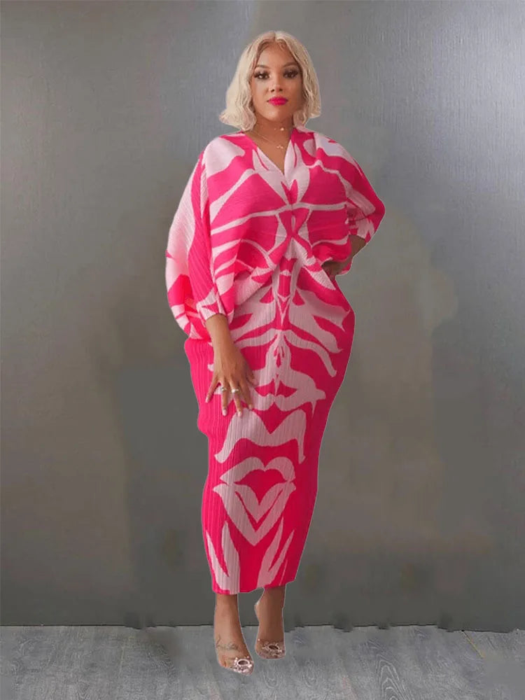Woman wearing a pink and white patterned dress against a plain background
