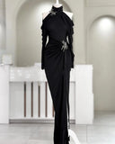 Black evening gown on a mannequin in a white room