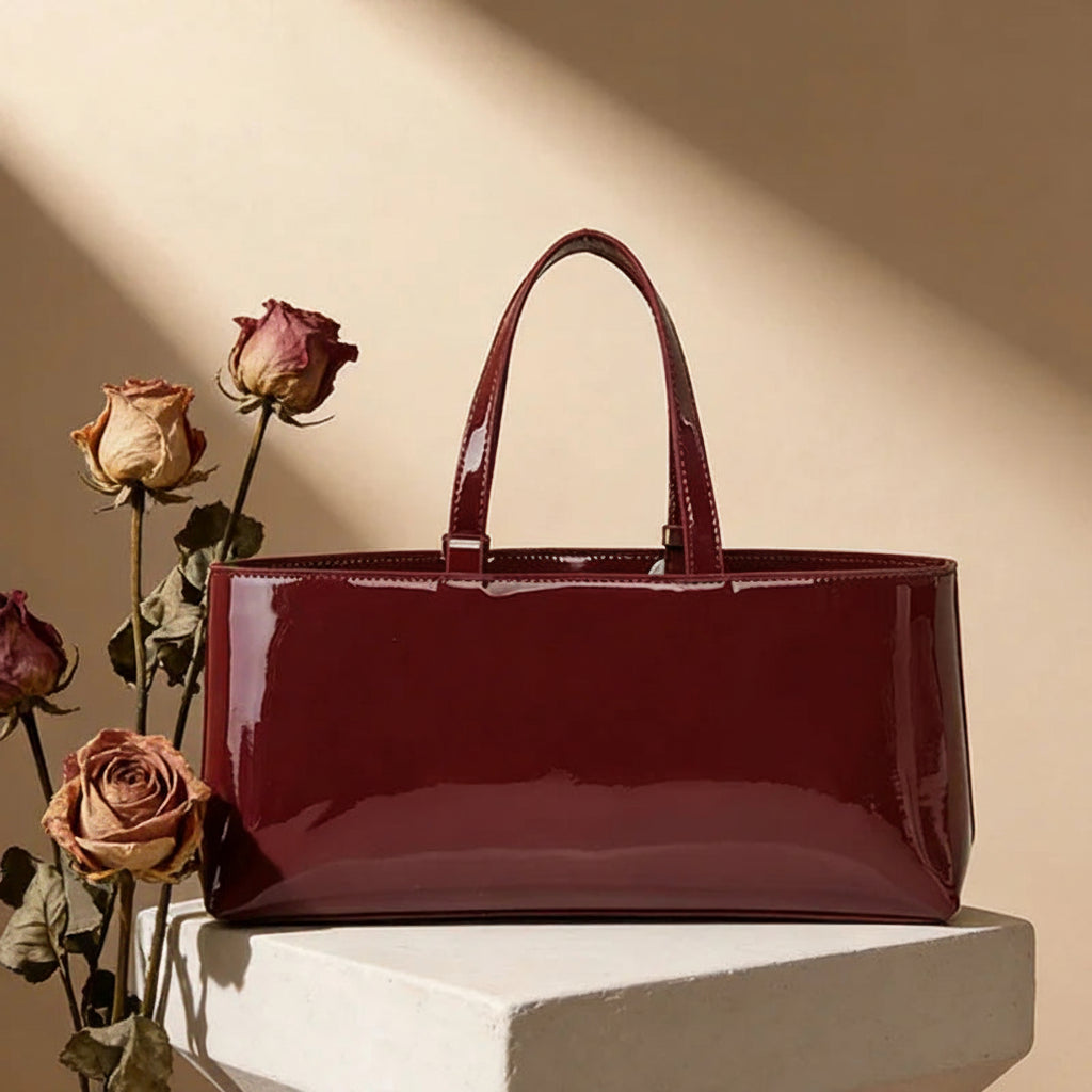 Red handbag with roses on a beige background, featuring VM Fashion Kiss branding.