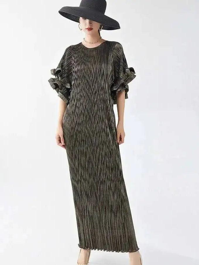 Person wearing a long patterned dress with ruffled sleeves and a wide-brimmed hat on a white background