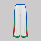 White pants with colorful stripes on a gray background