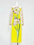 Yellow dress with floral design on a mannequin against a white background