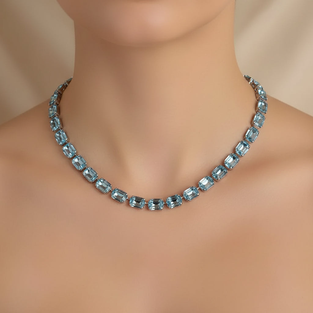 Necklace with blue gemstones on a beige background