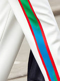 Close-up of a sash with red, green, and blue stripes on a white background