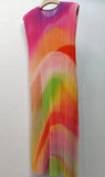 Colorful pleated dress on a hanger against a white background