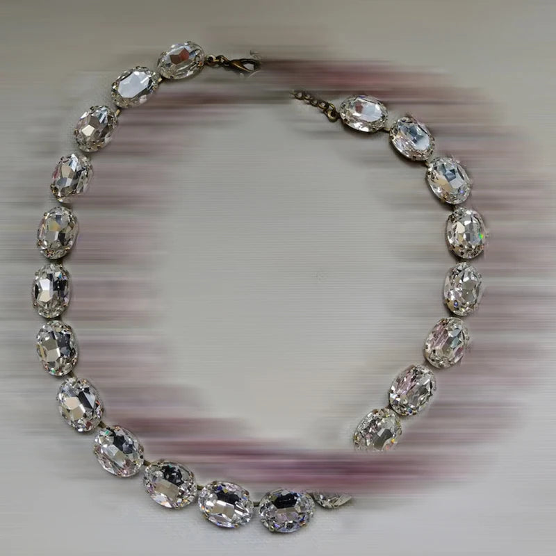 Necklace with clear gemstones on a textured gray background
