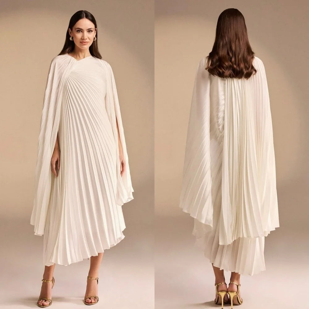 Woman wearing a white pleated dress with a cape, shown from front and back on a beige background.