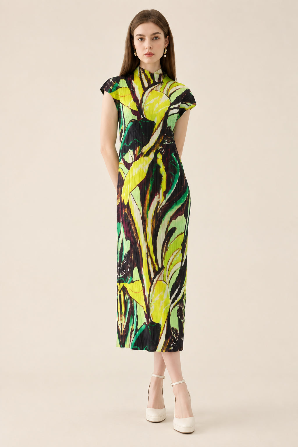 Woman wearing a colorful dress with a leaf pattern on a white background