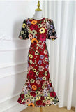 Colorful floral dress on a mannequin against a white background