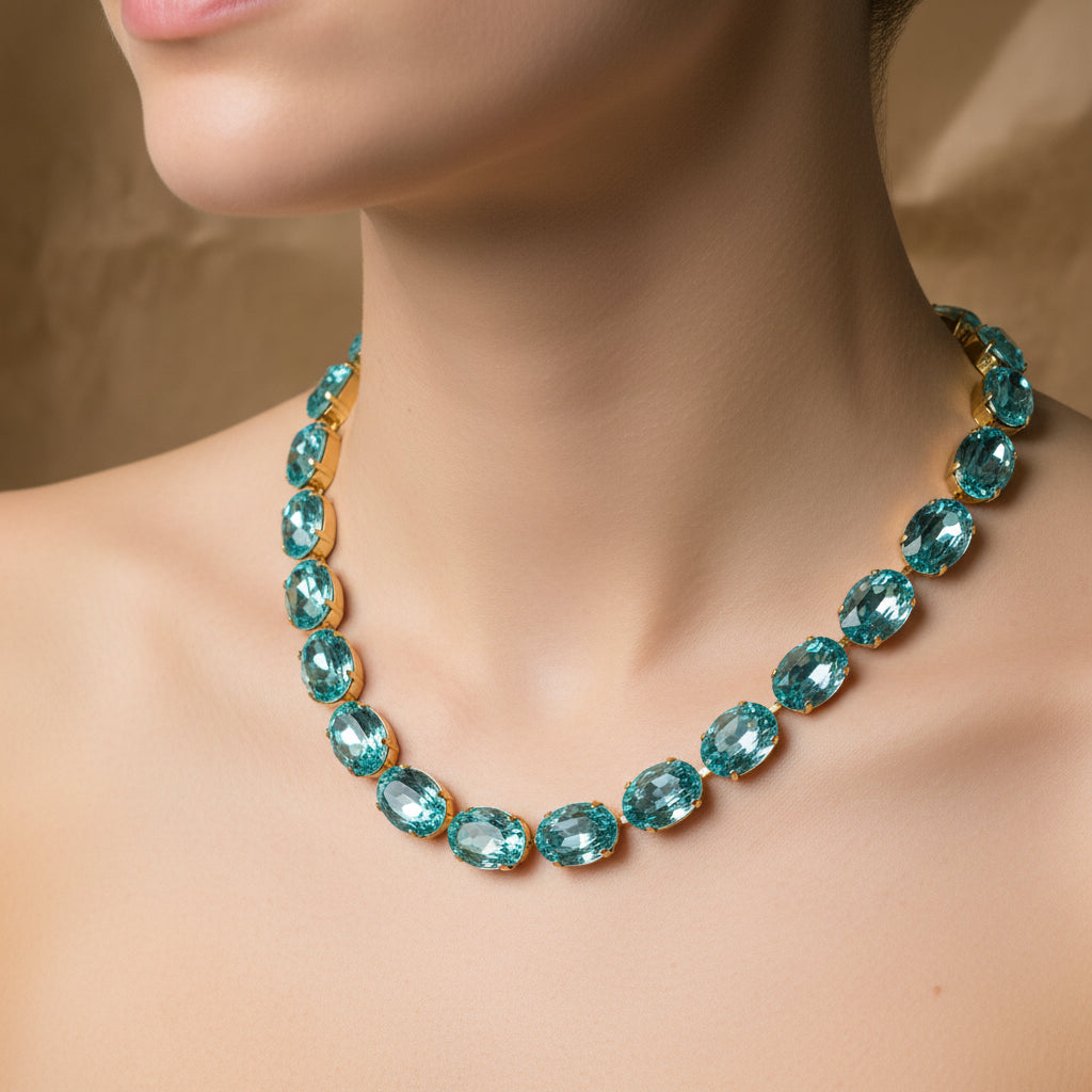 Necklace with blue gemstones on a mannequin bust against a beige background