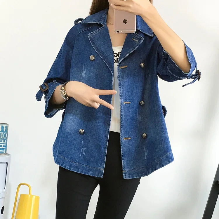 Person wearing a blue denim jacket with a white background