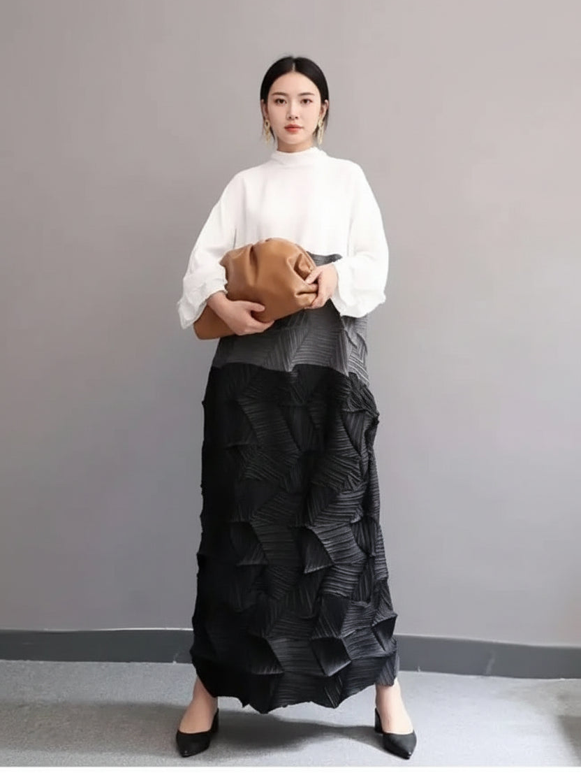 Person wearing a white blouse and black ruffled skirt holding a brown clutch against a plain background