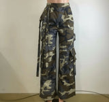 Camouflage pants on a mannequin against a plain background