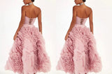 Pink strapless gown with floral details on a white background