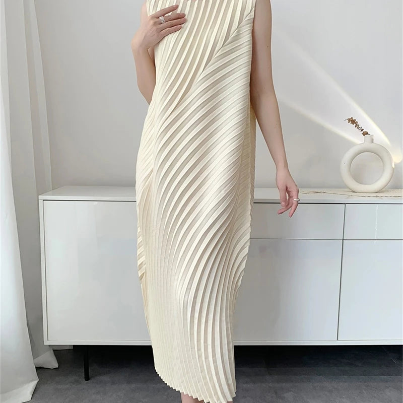 Person wearing a long, flowing white dress in a minimalistic room.