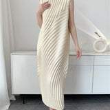 Person wearing a long, flowing white dress in a minimalistic room.