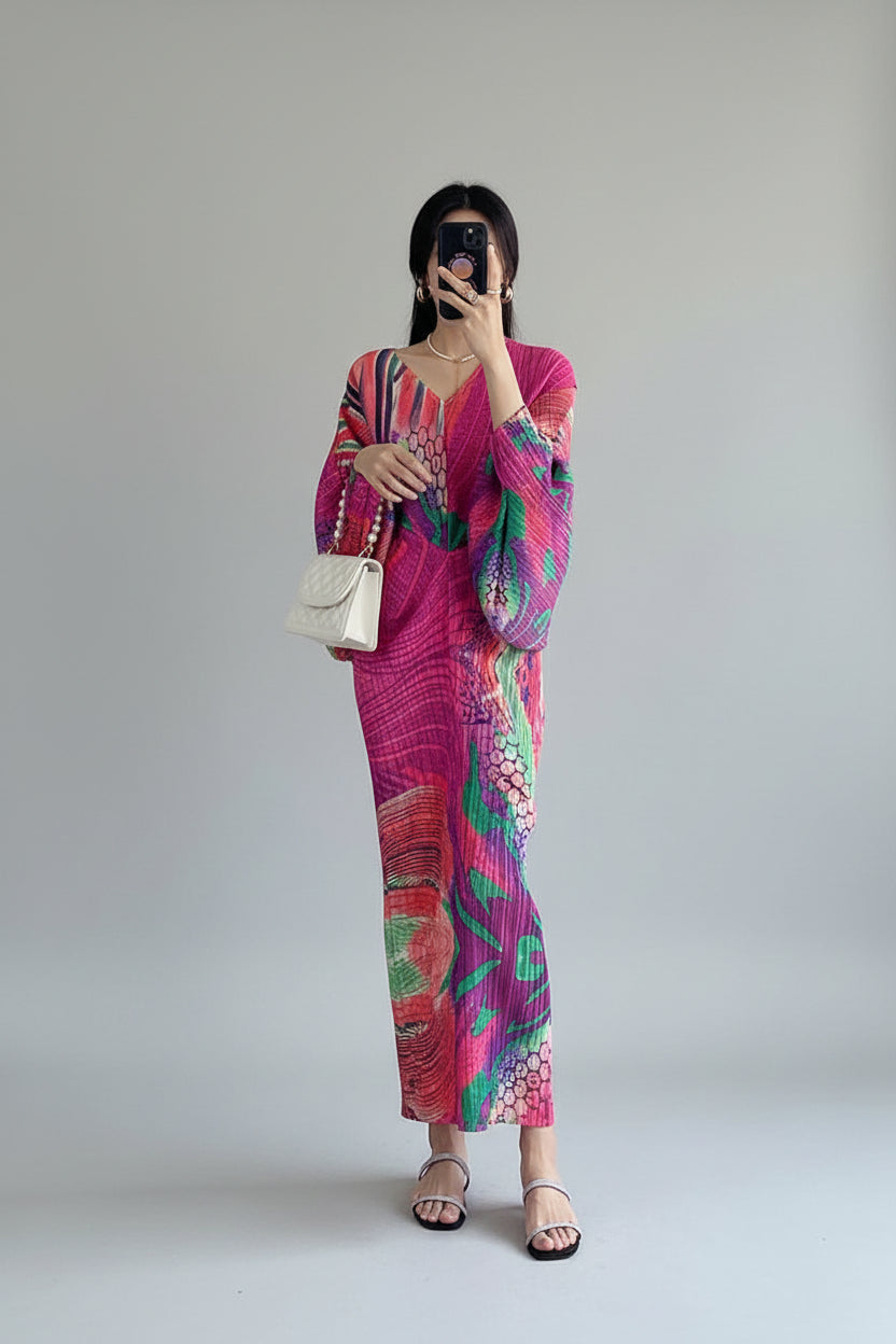 Person wearing a colorful outfit with a white handbag in a room.