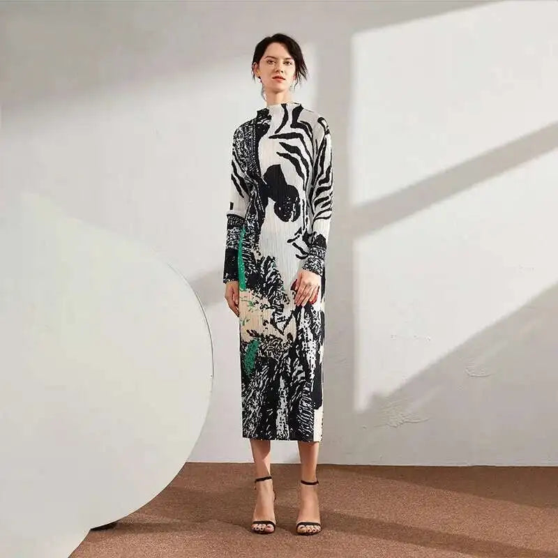 Woman wearing a patterned dress standing against a white wall with a large circular object.