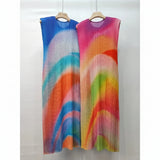 Two colorful dresses on hangers with a plain background