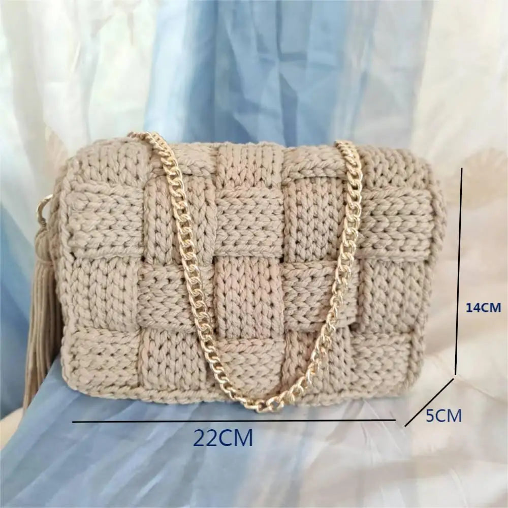 Knitted handbag with gold chain strap and measurements on a light blue fabric background