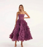 Woman wearing a strapless, ruffled purple dress on a white background with 'yipeisha' branding.