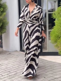 Person wearing a zebra print dress standing outdoors.