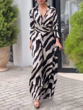 Person wearing a zebra print dress standing outdoors.