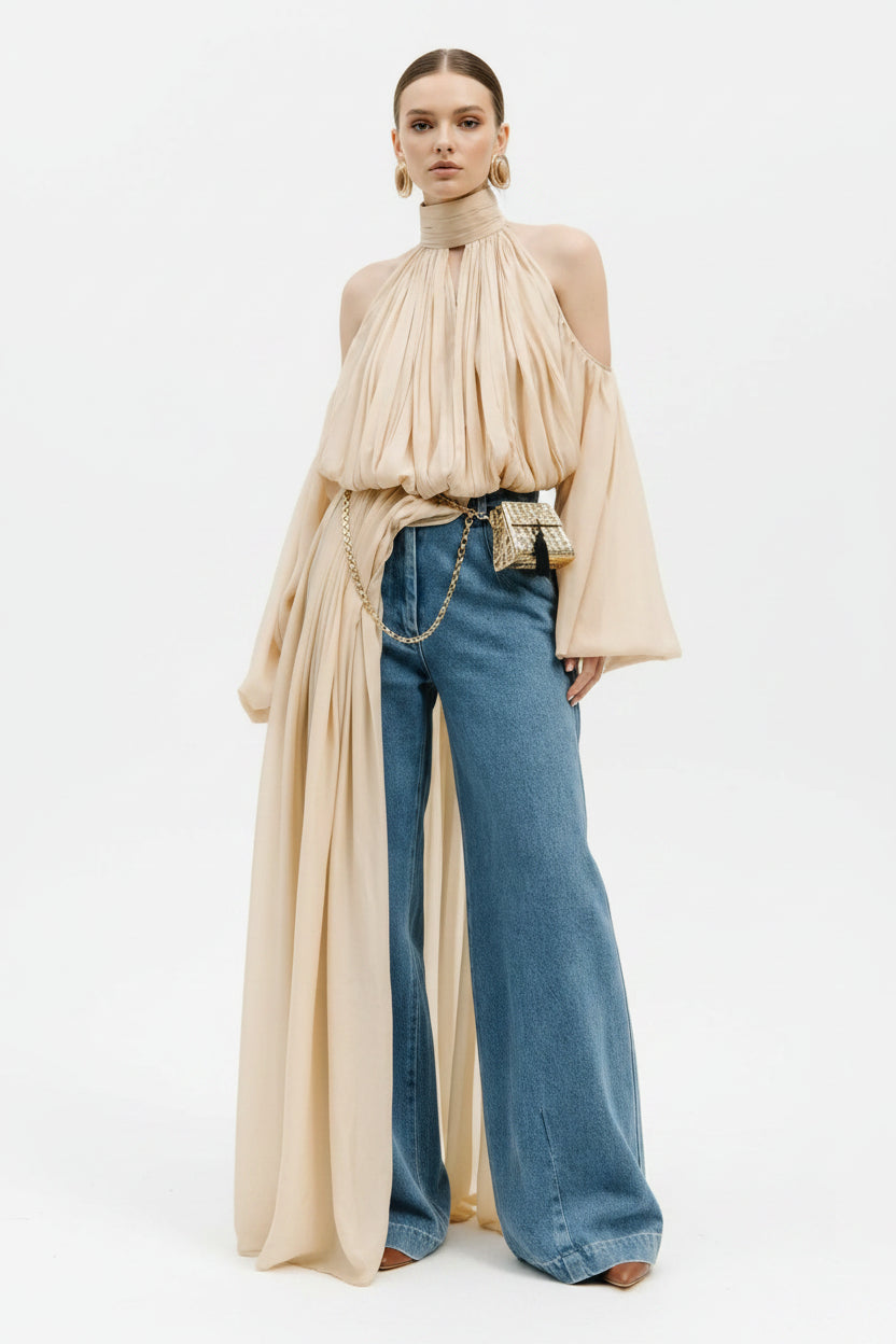 Person wearing a beige off-shoulder top and blue jeans in an elegant interior setting with 'TWO-TWINSTYLE' branding.