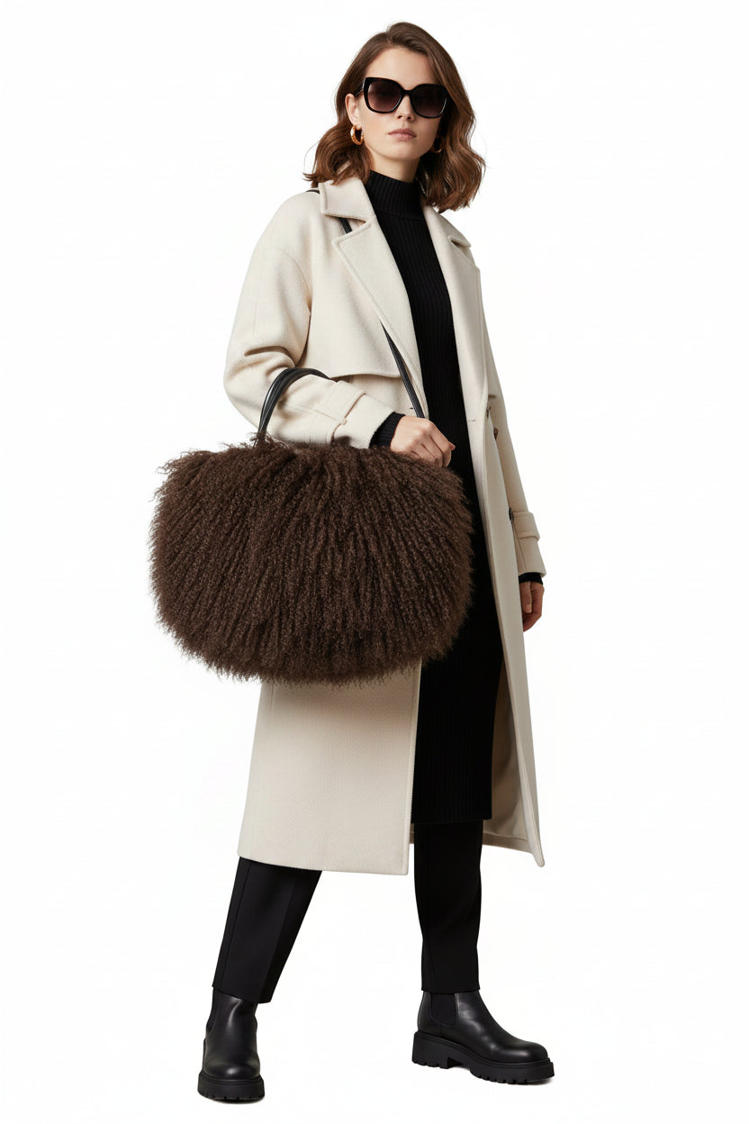 Brown fluffy handbag with a black handle on a white background