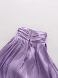 Purple dress with a bow detail on a light gray background