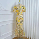 Floral dress on a mannequin against a white curtain background