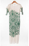 White dress with green floral pattern hanging in a closet