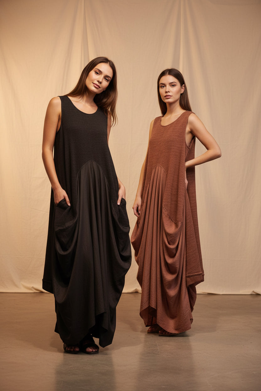 Two sleeveless dresses, one black and one brown, on hangers against a white background.